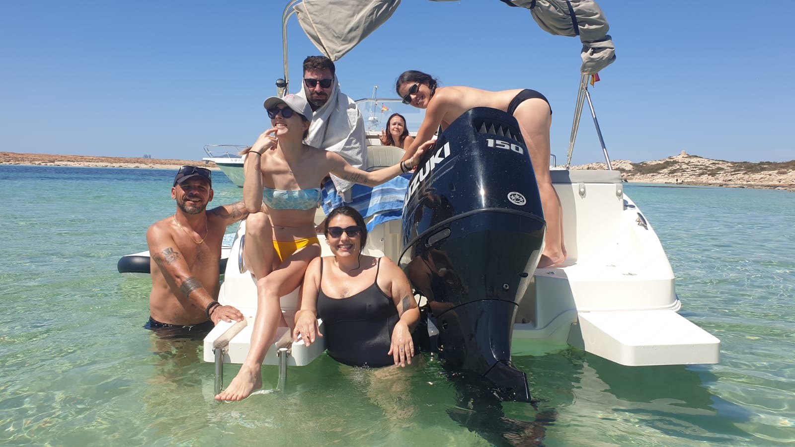 Group enjoying Buena Proa Ibiza in crystal-clear waters