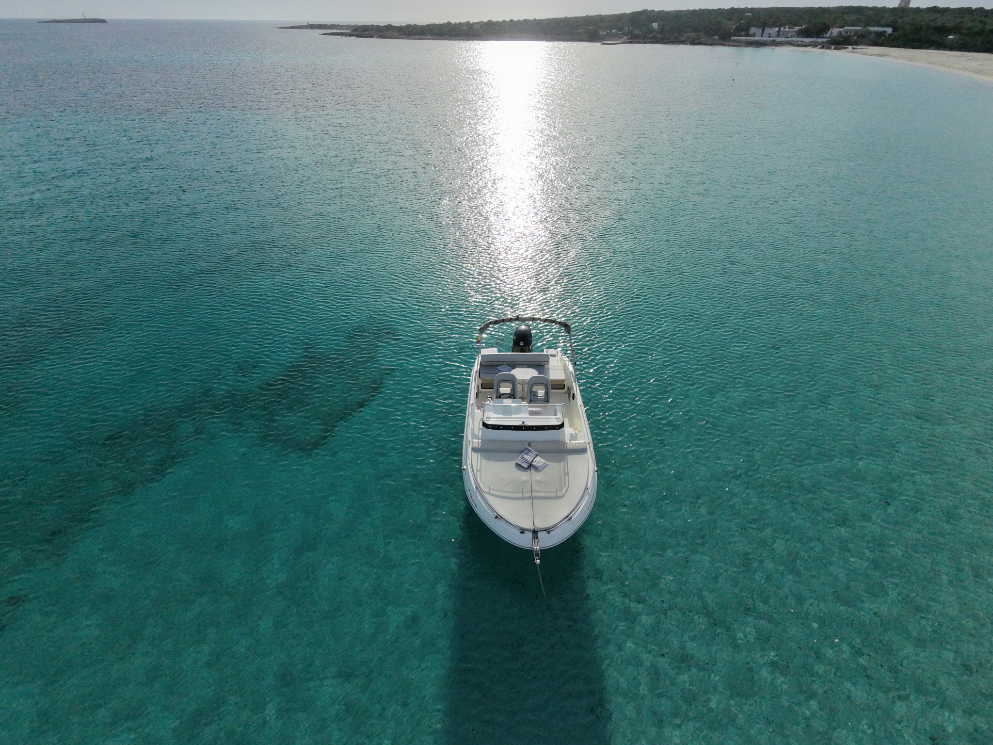 Buena Proa seen from drone with sunlight on the water