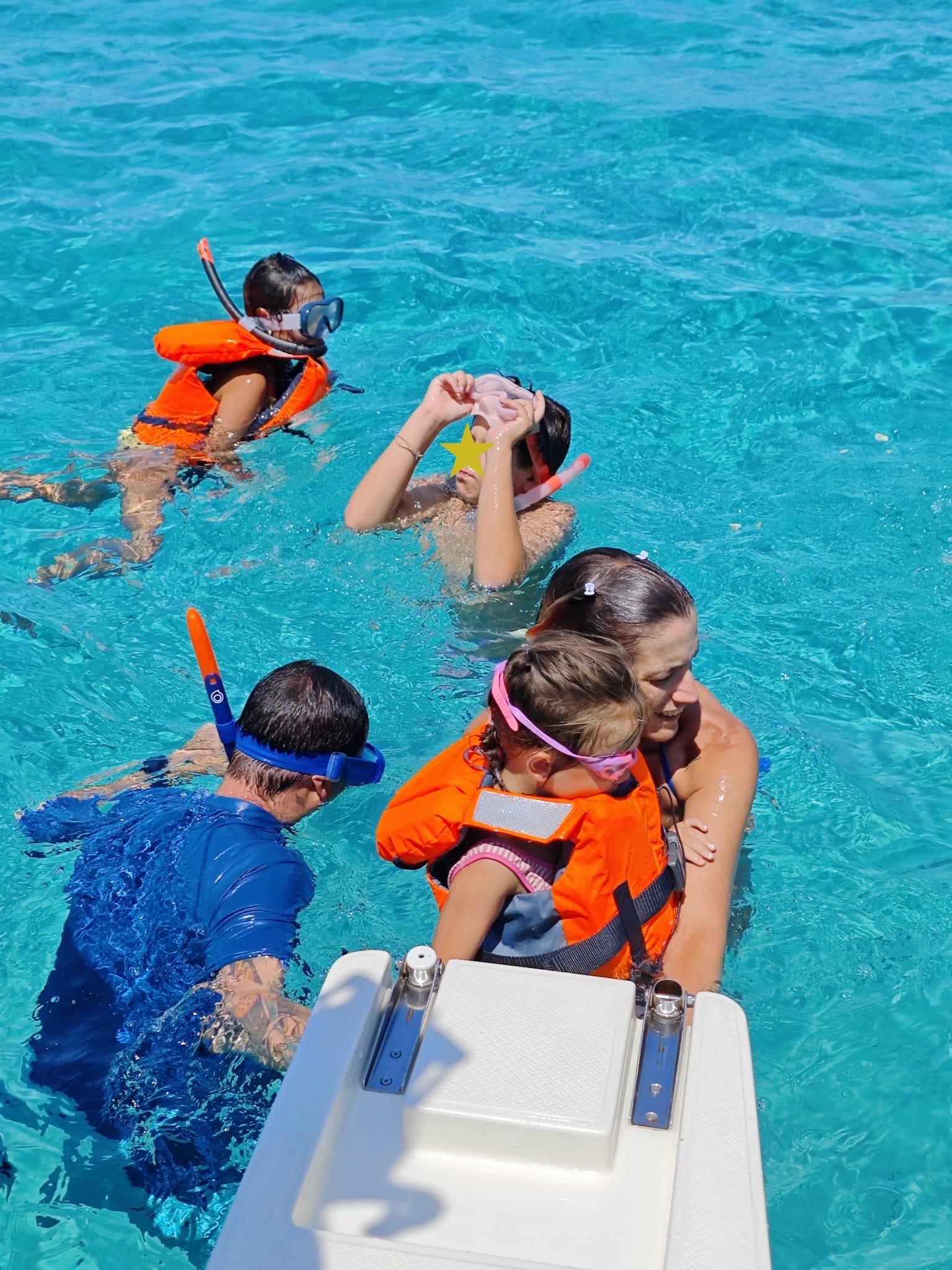 Family snorkelling in crystal-clear waters