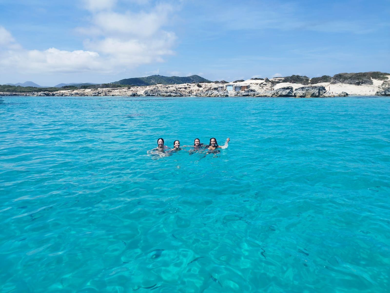Group of friends swimming in turquoise waters
