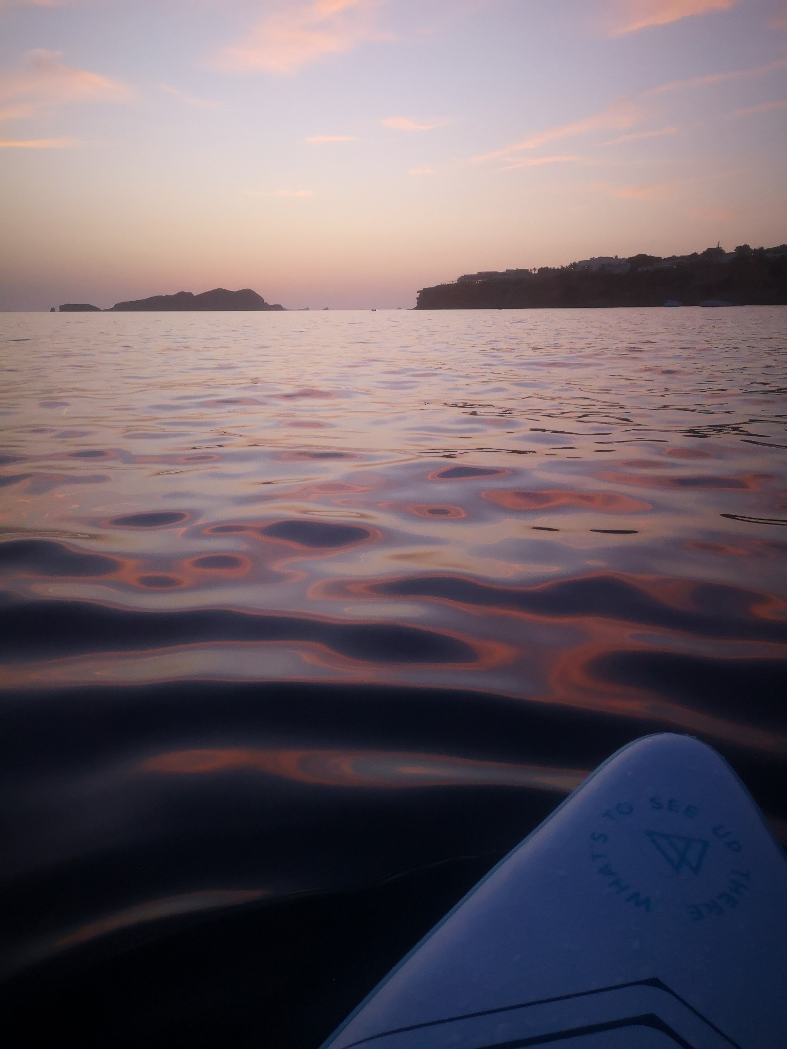 Paddle board on blue waters with a sea horizon